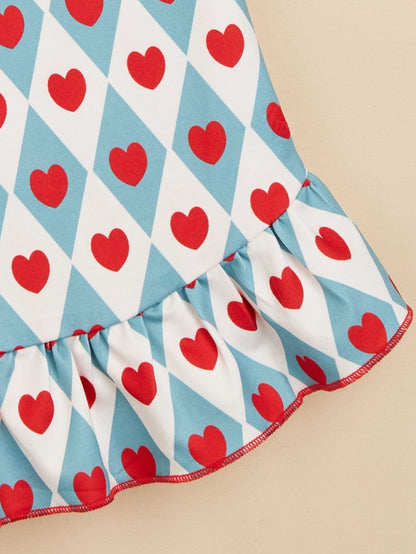 Small dog walking outdoors wearing Ozzie cute heart pattern dress