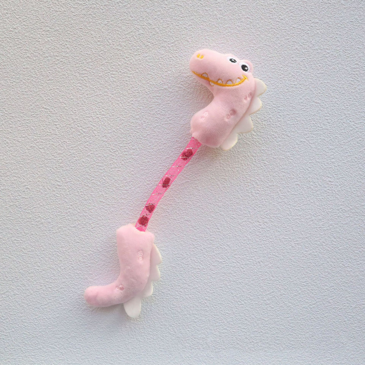 Moo Dinosaur cat toy with visible stitching and soft plush material