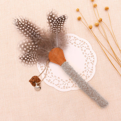 Moo feather cat toy with multiple colorful feathers fanned out