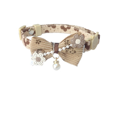 Mokka bow cat collar with floral charm shown with close-up of clasp