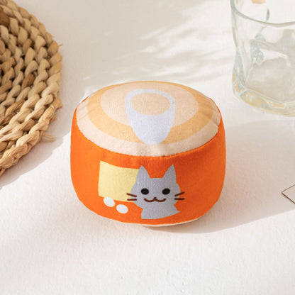 Moo plush can cat toy positioned upright on flat surface
