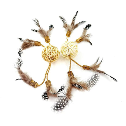 Set of natural rattan cat toy balls with feathers and silvervine on a white background
