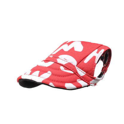 Small dog resting on grass wearing Ozzie visor cap