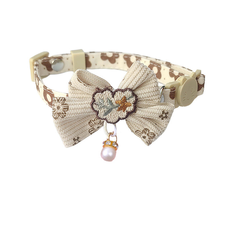 Mokka bow cat collar worn by a cat with visible floral charm and bow