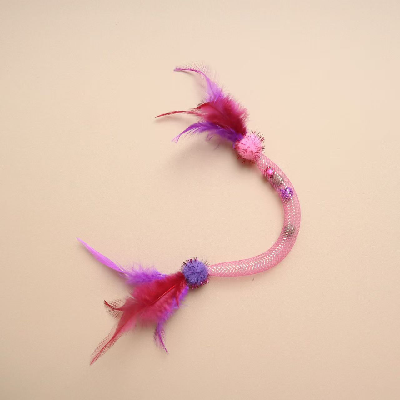 Close-up of Moo Sparkle Feather Toss cat toy showing vibrant feathers and sparkles