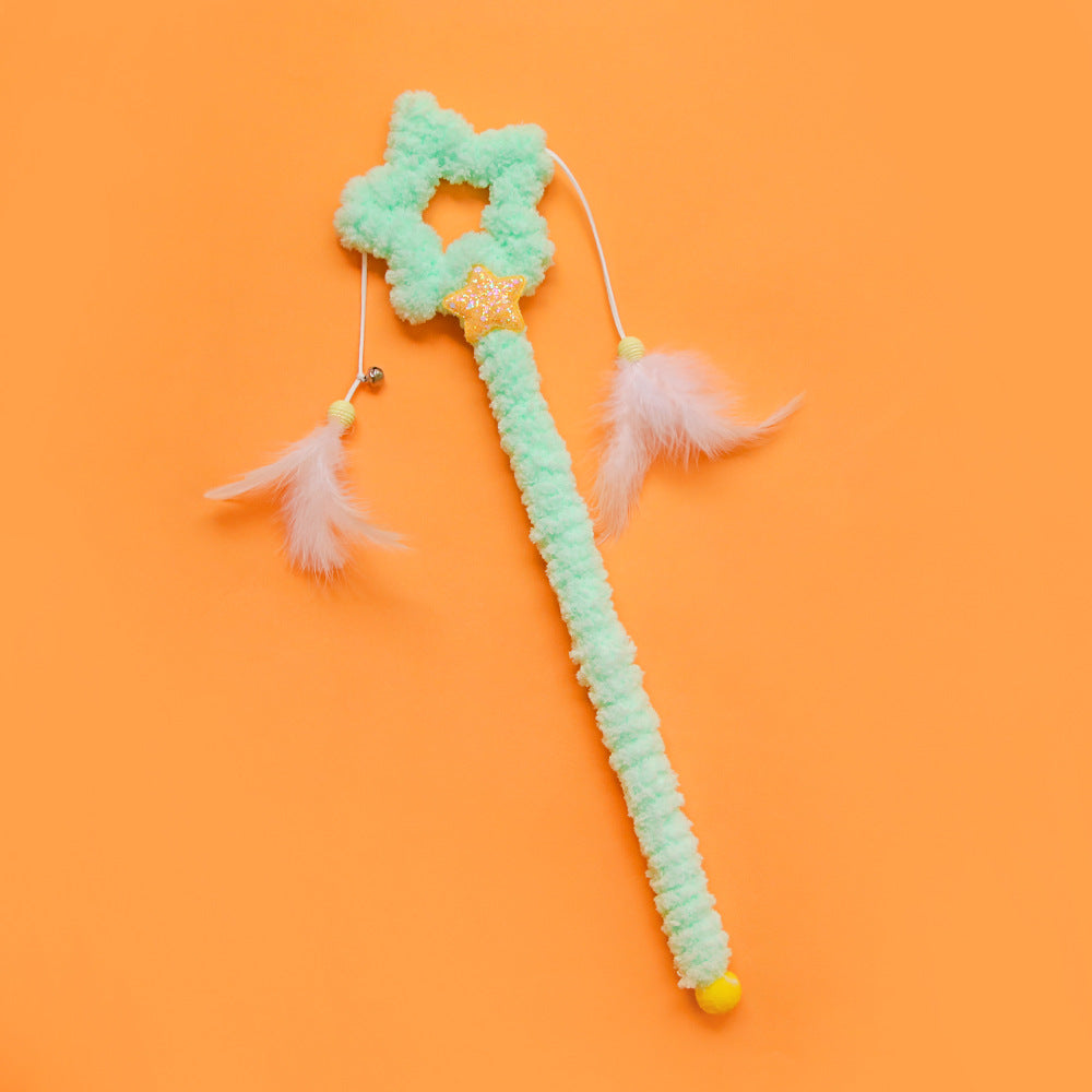 Close-up of the pink heart-shaped handle on the Moo Feather Cat Teaser Wand