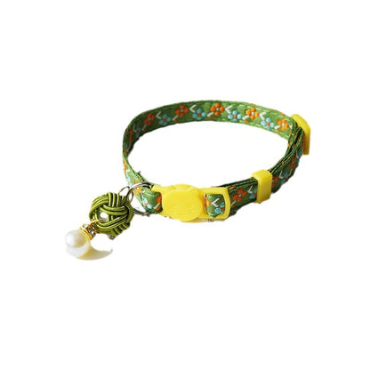 Mokka Pearl Flower Cat Collar with pearl flower on a light surface