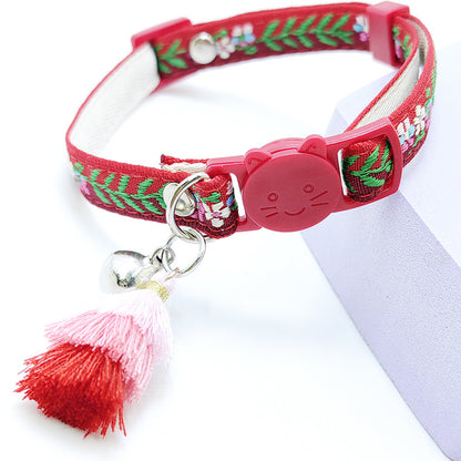 Close-up of Mokka floral cat collar showing adjustable strap and fringed edges