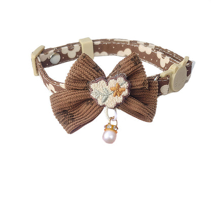 Top view of Mokka bow cat collar showing bow and floral charm on strap