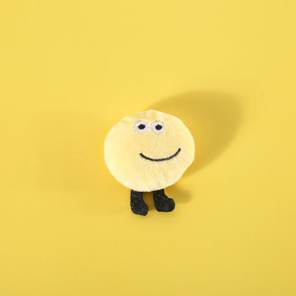Close-up of a bread cat toy shaped like a baguette with a smiling face