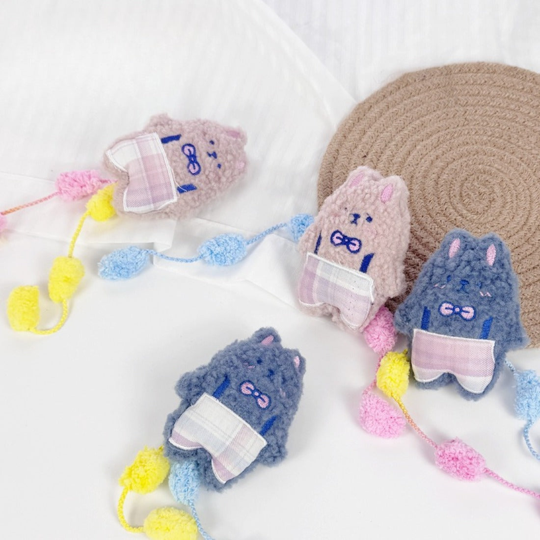 Moo plush cat toy with soft fabric and colorful pom tail on white background