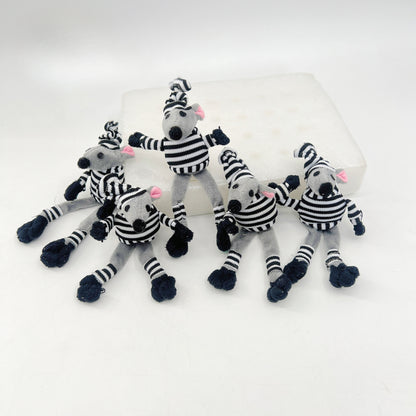 Moo mouse shape cat toy positioned on a wooden surface