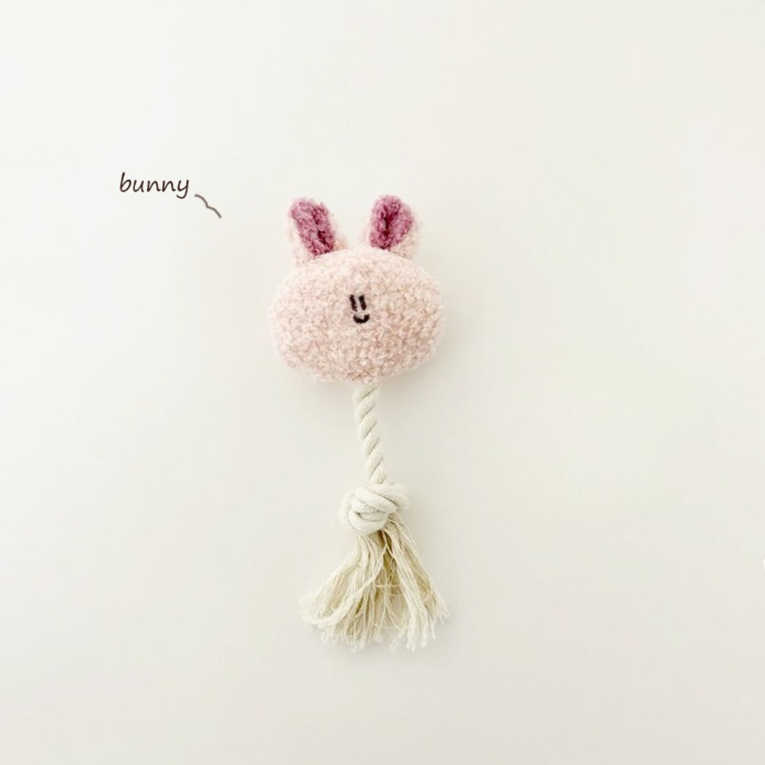 Petkin plush dog toy showing soft fabric body and rope tail detail