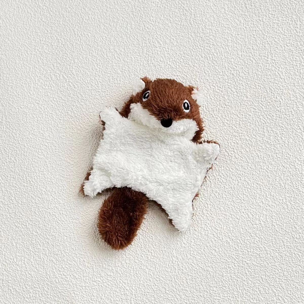 Plush squirrel kicker cat toy with visible seams and fluffy tail close-up