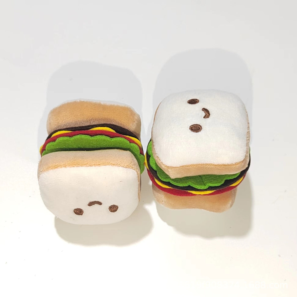 Moo plush hamburger cat toy held in hand to show size and texture