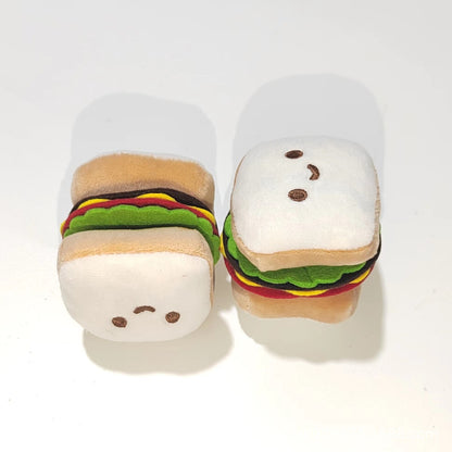 Moo plush hamburger cat toy held in hand to show size and texture