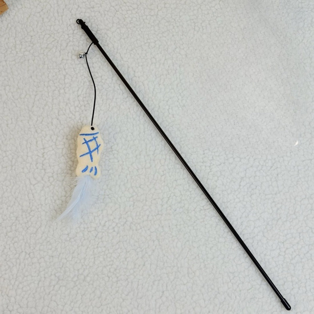 Cat playing with the Moo Cookie plush teaser wand featuring feather and cookie plush