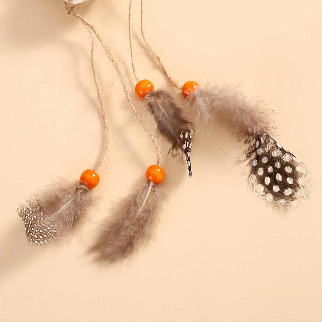 Side view of the Moo Lion hanging cat toy showing the full length and feather teaser