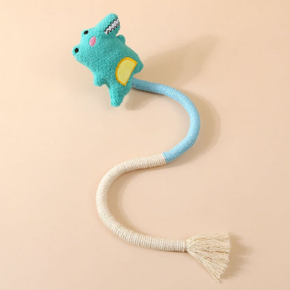Moo wand toy held by hand showing flexible string and plush charm