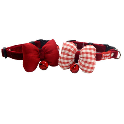 Red bow bell breakaway cat collar with adjustable strap on white background