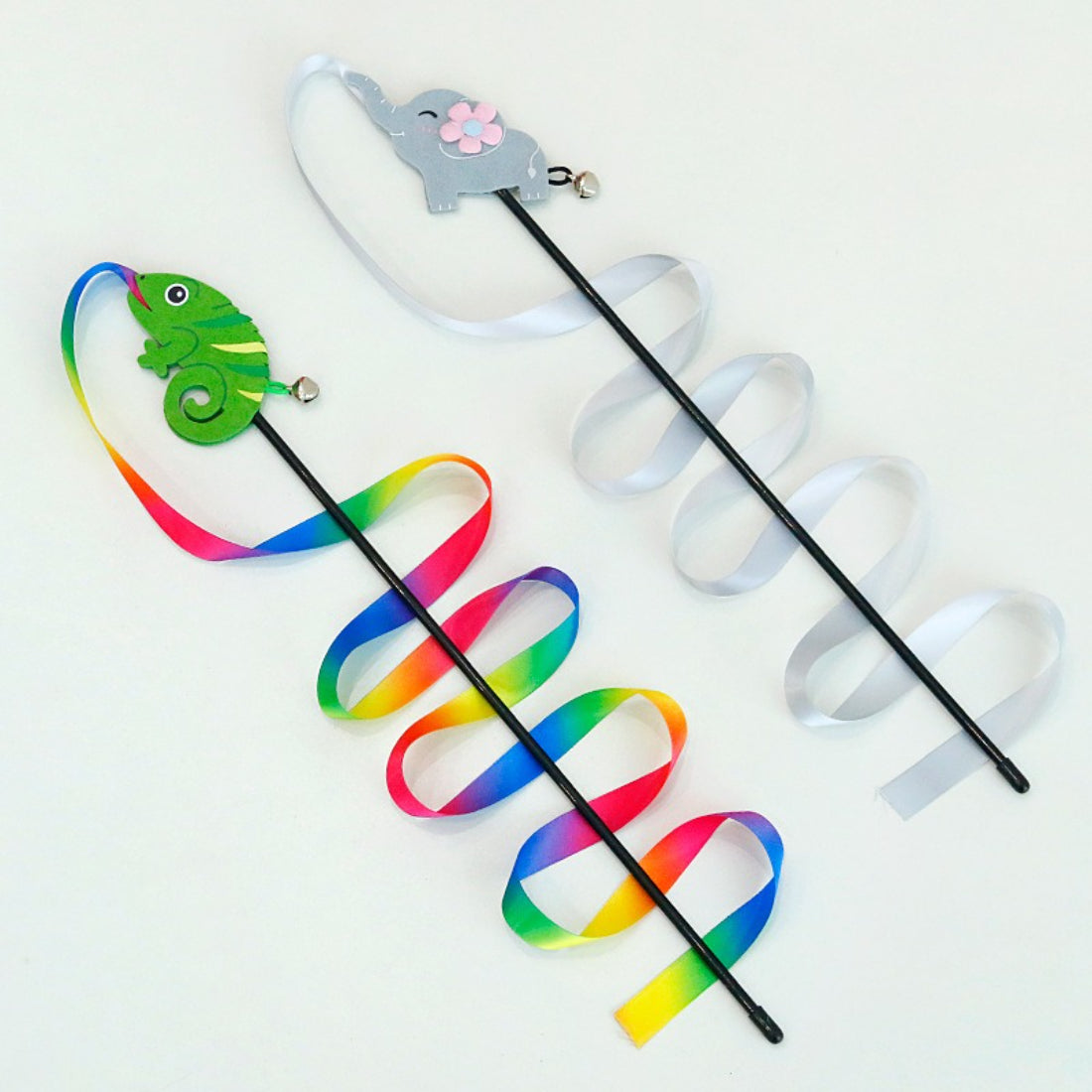 Close-up of colorful ribbons on the wand cat toy showing bright pink, blue, and yellow ribbons