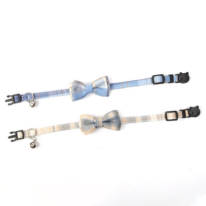 Mokka cat collar with black and white checkered bow tie displayed flat with adjustable buckle