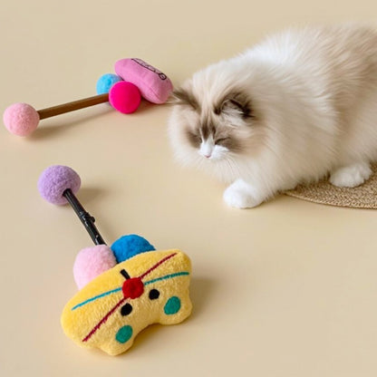 Moo cat stick toy held by hand demonstrating size and flexible stick