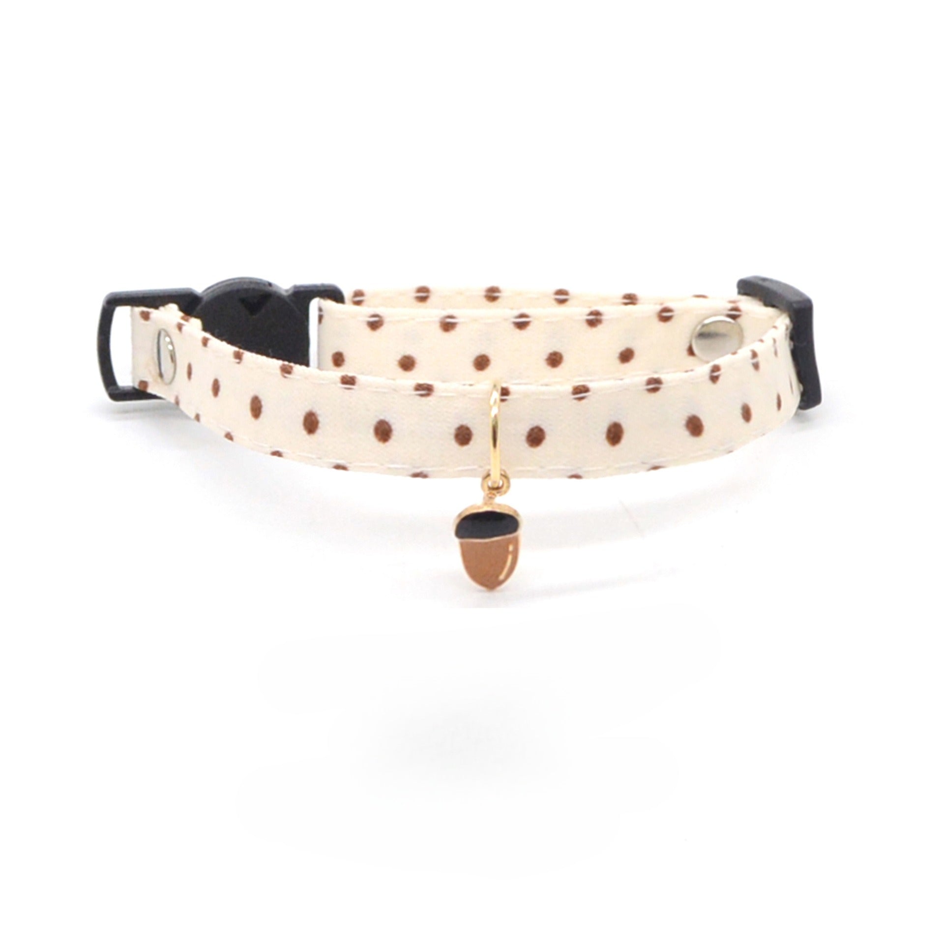 Close-up of silver carrot charm on orange breakaway cat collar