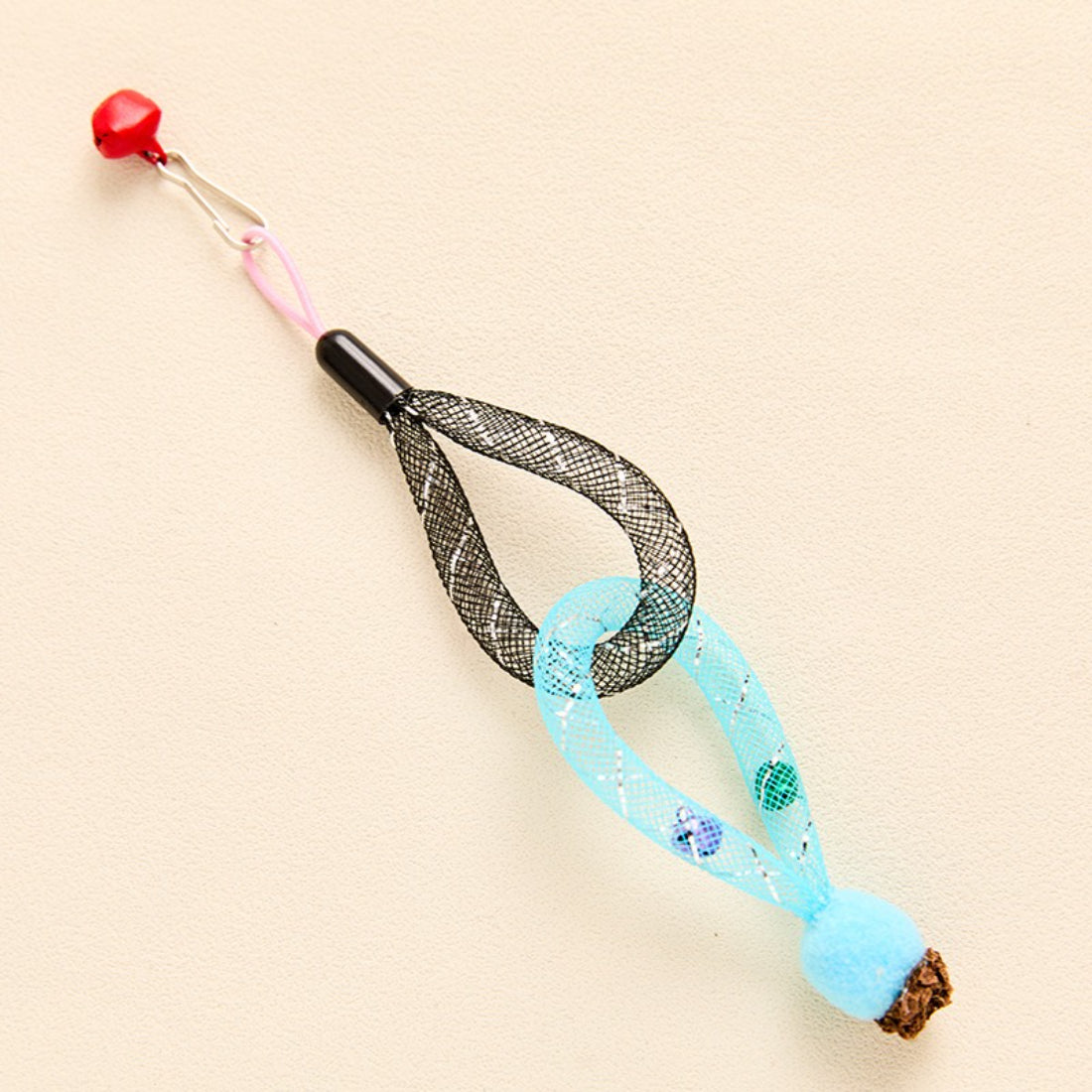 Moo mesh tube cat toy with bell partially coiled