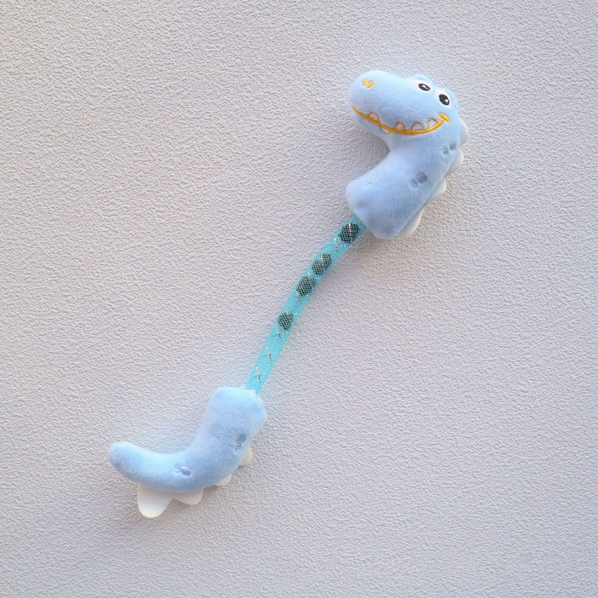 Moo Dinosaur cat toy positioned upright to show tail and head details