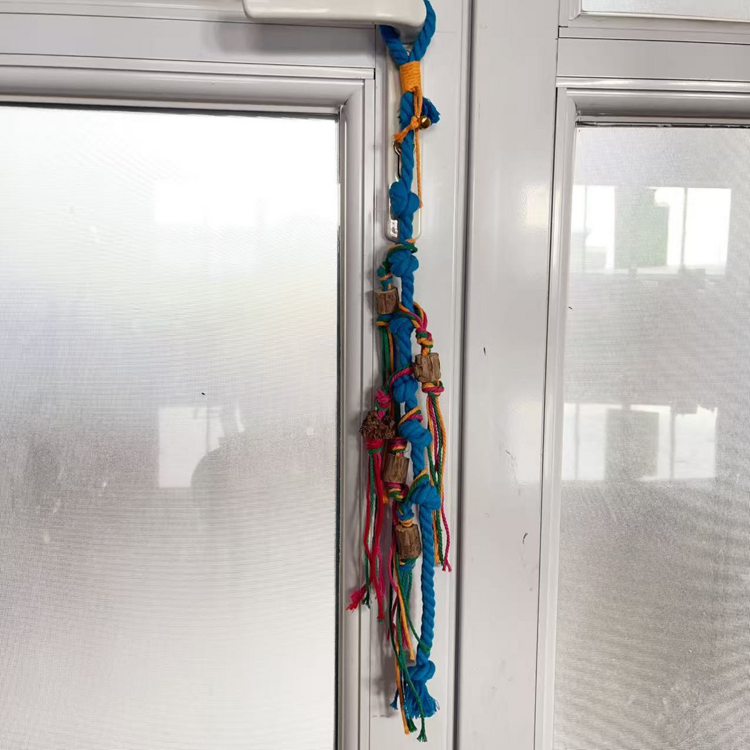 Blue knotted rope cat toy hanging from a window handle