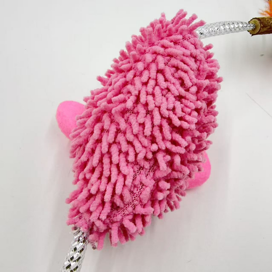 Close-up of the pink mouse-shaped cat toy's tufted surface and visible seam