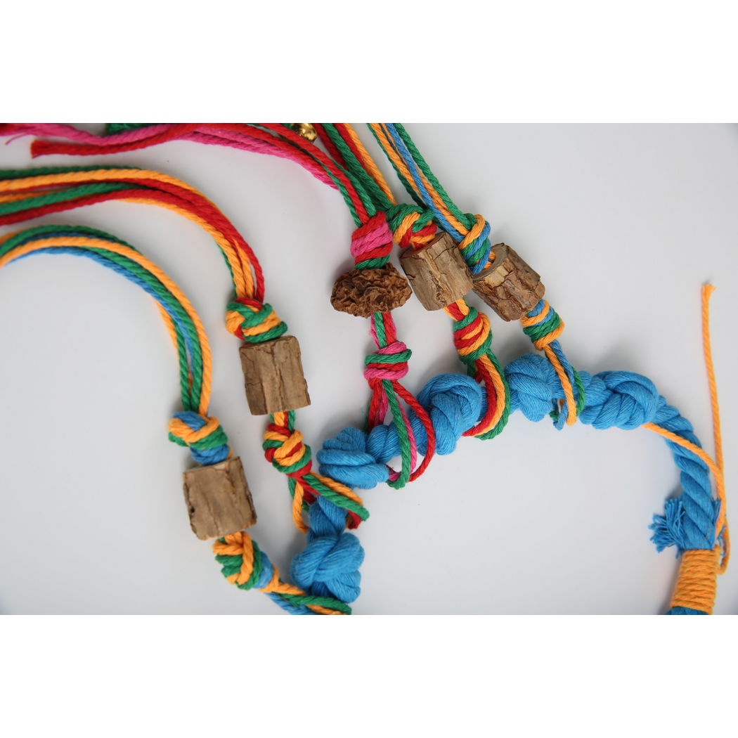 Close-up of Blue rope knots, multicolored cords and cylindrical pieces