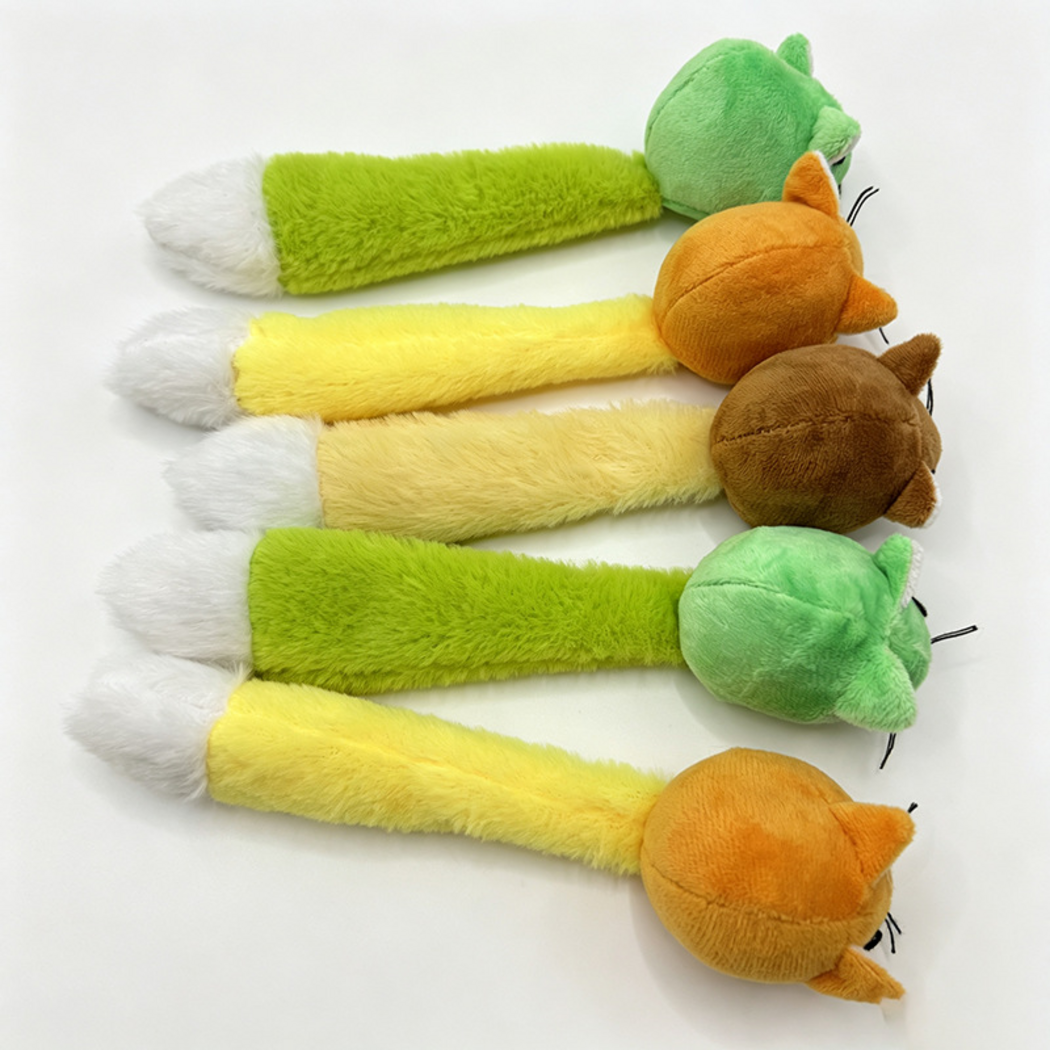 Rear view of Green, Orange and Brown mouse-shaped cat toys with white-tipped tails
