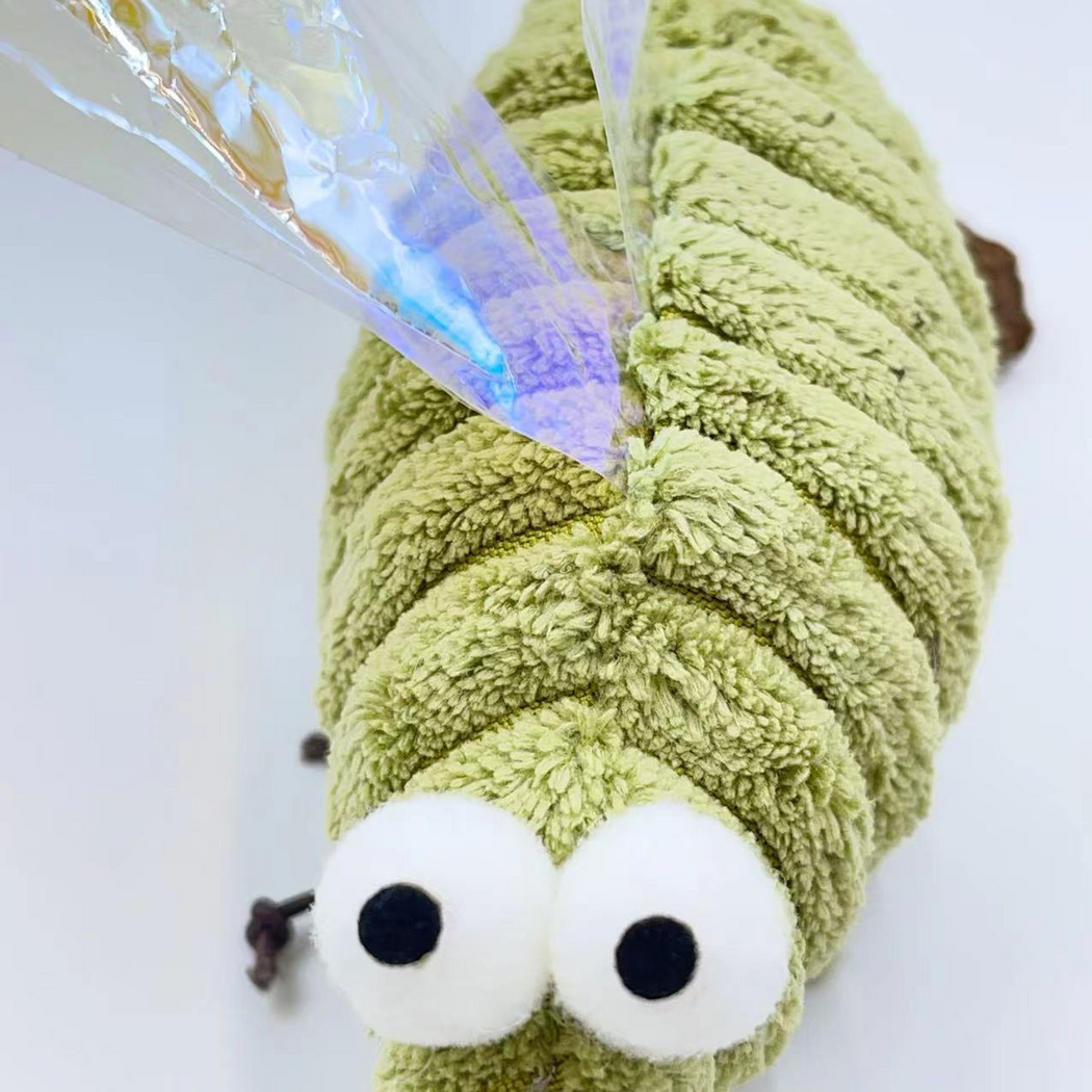 Close-up of the Mosquito cat toy's white eyes, ribbed green surface and wing attachment