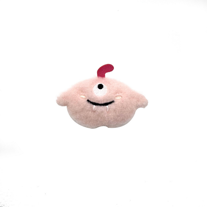 Pink One-eyed plush cat toy with a red top appendage and stitched teeth, front view