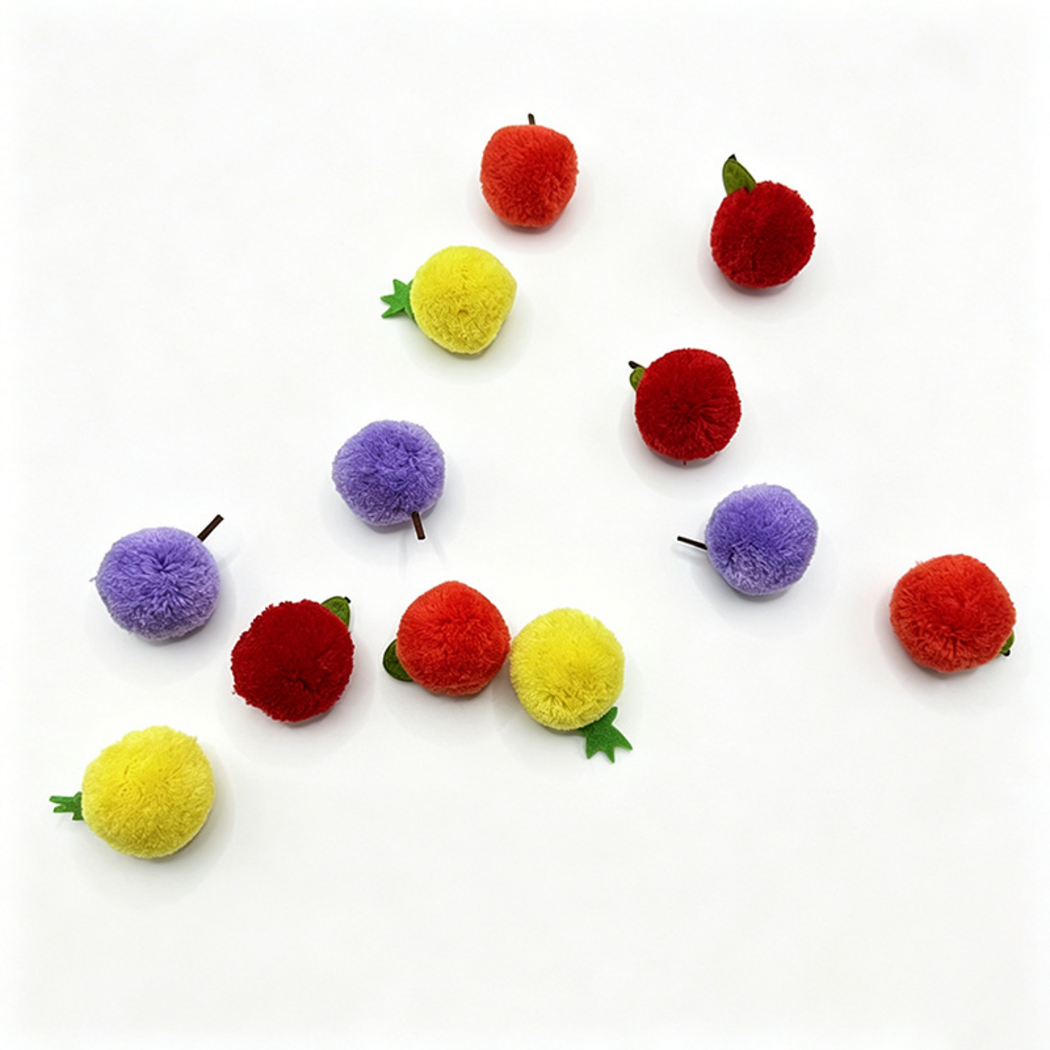 Fruit-shaped ball cat toys viewed from above with several stems and leafy tops turned sideways
