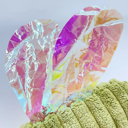Close-up of the Mosquito cat toy's creased iridescent wings and green ribbed body