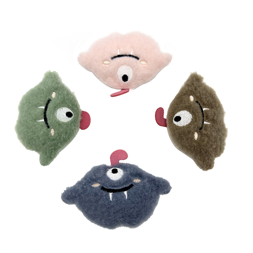 Pink, green, brown and blue one-eyed monster cat toys spread in a circle