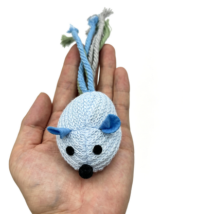 Mouse-shaped cat toy resting in an open hand, showing its knitted body and rope tail