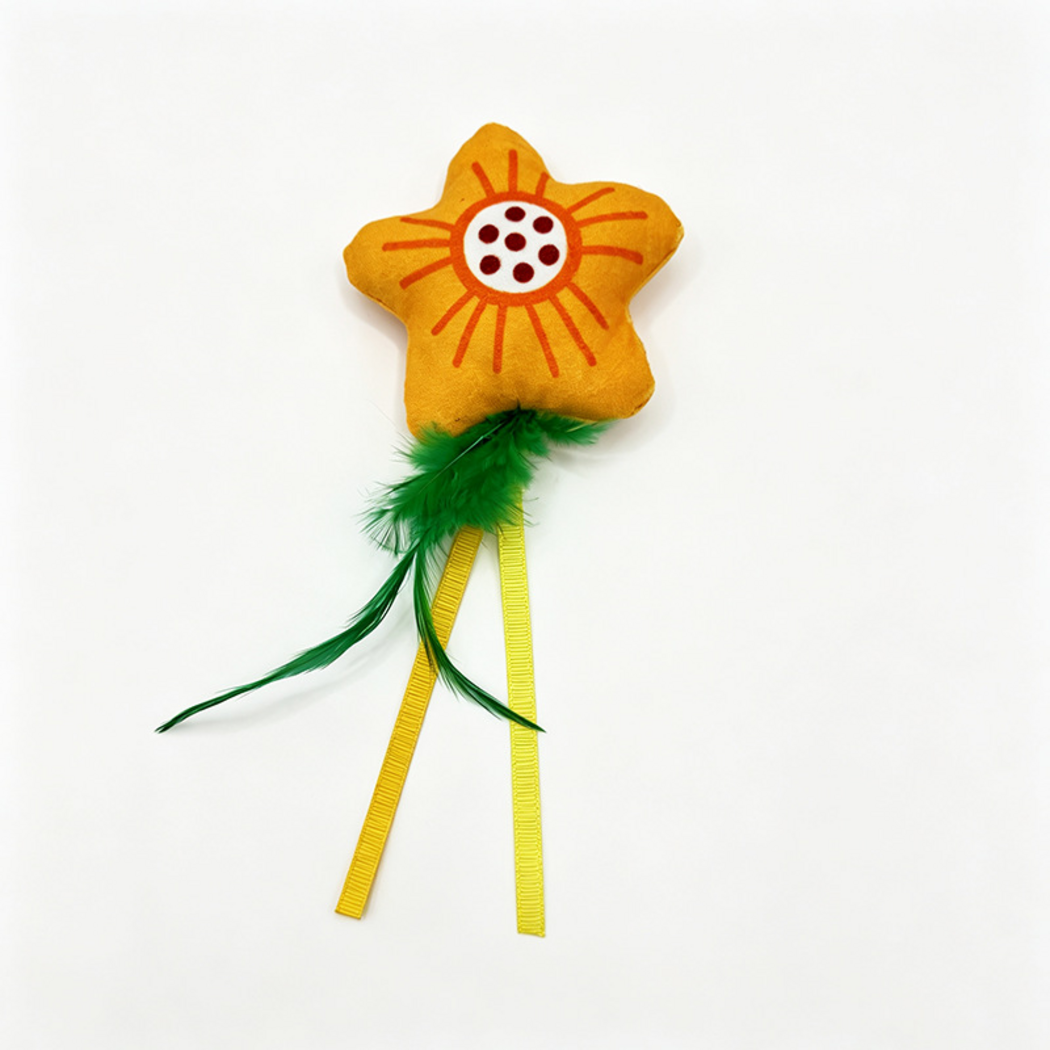 Flower cat toy with a yellow-orange patterned body, green feather-like tails and two yellow ribbons