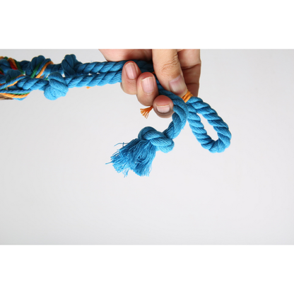 Hand holding the Blue cat toy's rope loop beside a knotted tassel end