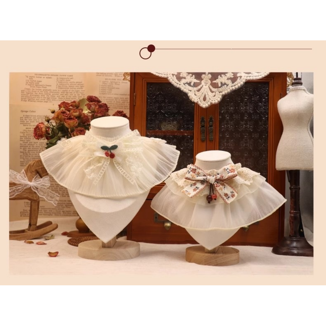 Cherry and Floral Pet Neckwear displayed side by side on separate busts