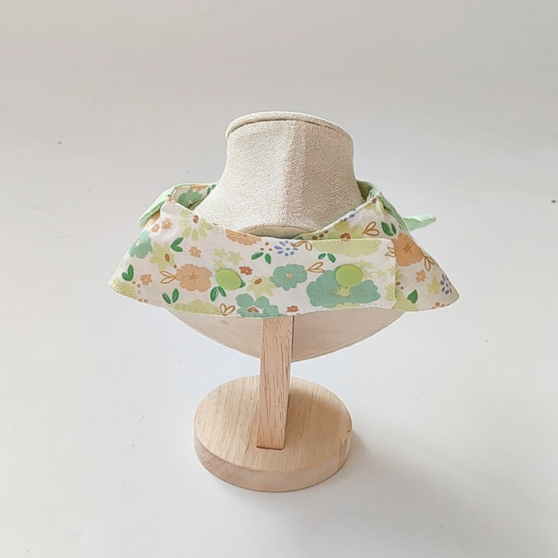 Mokka flower print cat neck bib fastened around a cat's neck