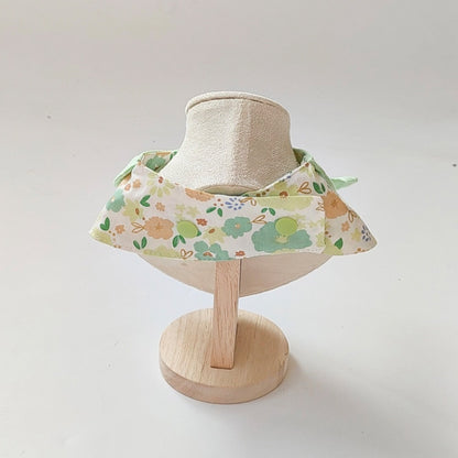 Mokka flower print cat neck bib fastened around a cat's neck