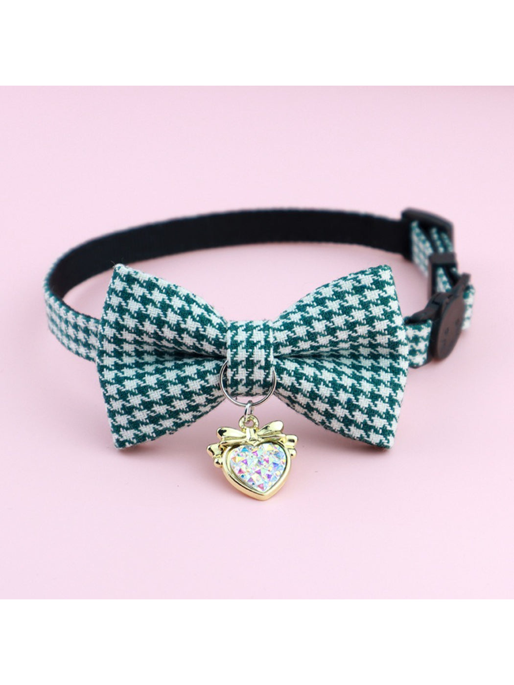 Close-up of bell attached to Mokka houndstooth bow cat collar