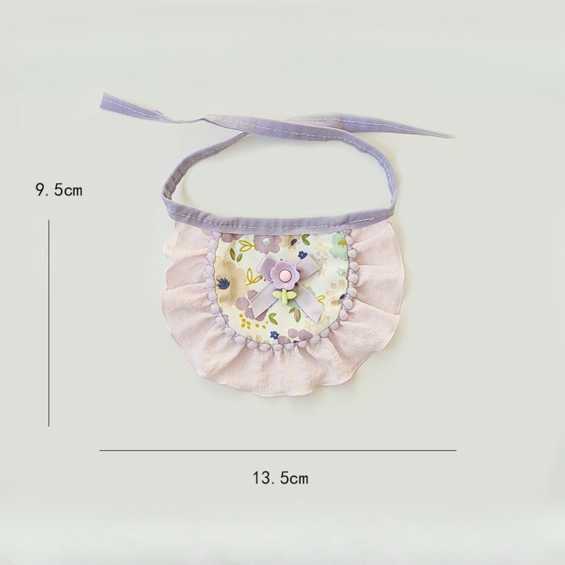 Side view of cat wearing Mokka floral bow bib showing comfortable fit around neck