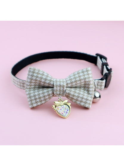 Mokka cat collar with houndstooth bow and bell shown from top angle