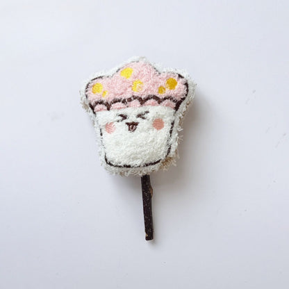 Side view of Moo plush cat stick toy showing its thickness and fabric texture