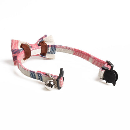 Red and black plaid bow tie attached to adjustable cat collar with breakaway feature
